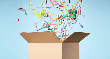 cardboard box with streamers exploding out